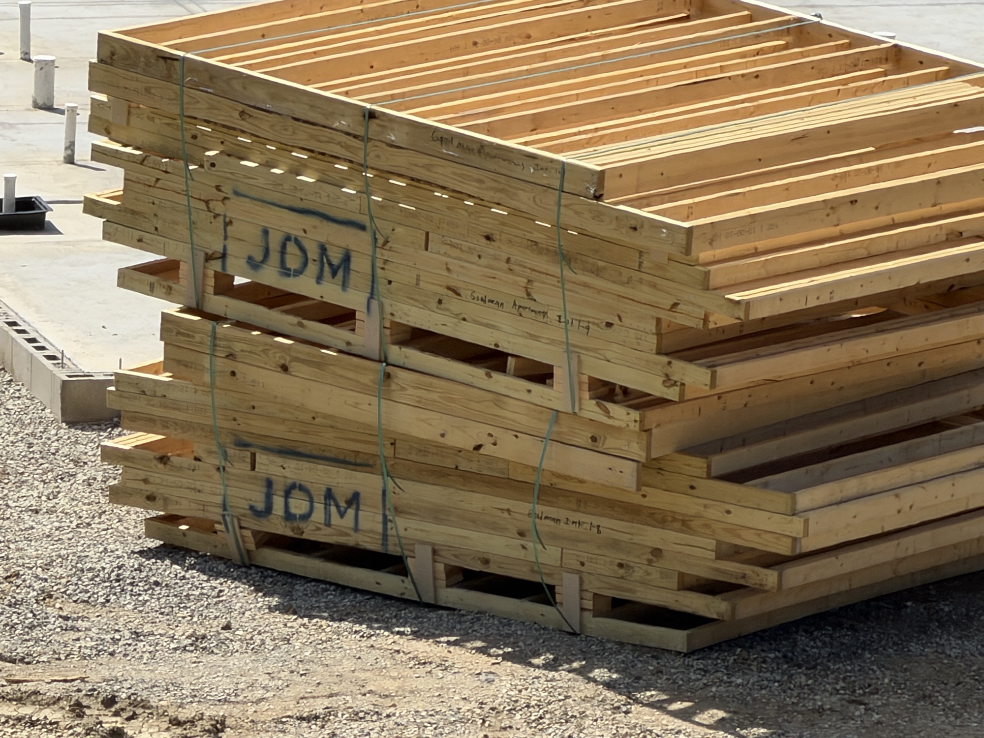 Real construction photo: close-up of prefabricated JDM floor truss packages delivered for The Legacy at Richland Commons, July 30, 2026