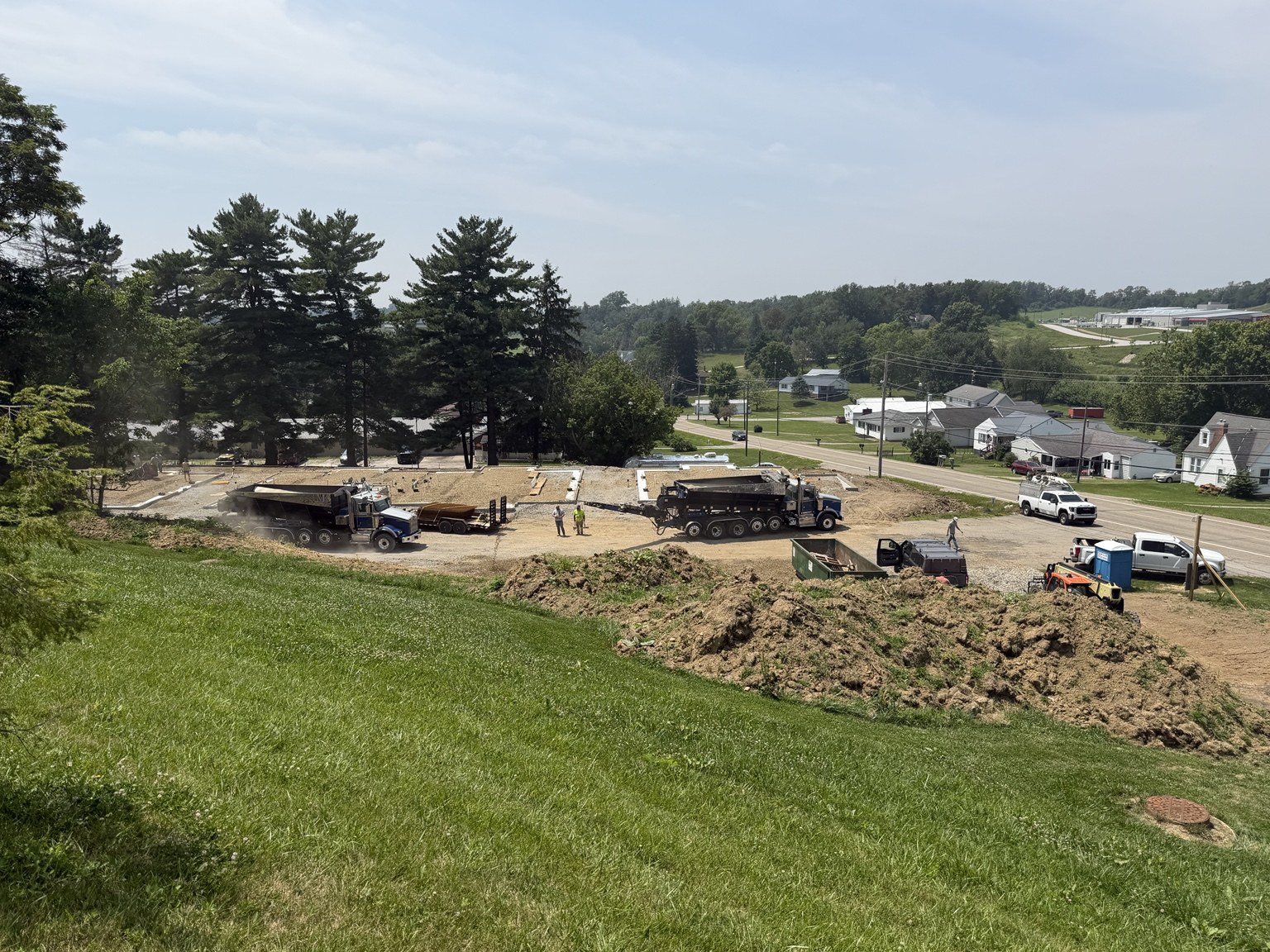Real construction photo: full site view of foundation progress at The Legacy at Richland Commons, July 20, 2026