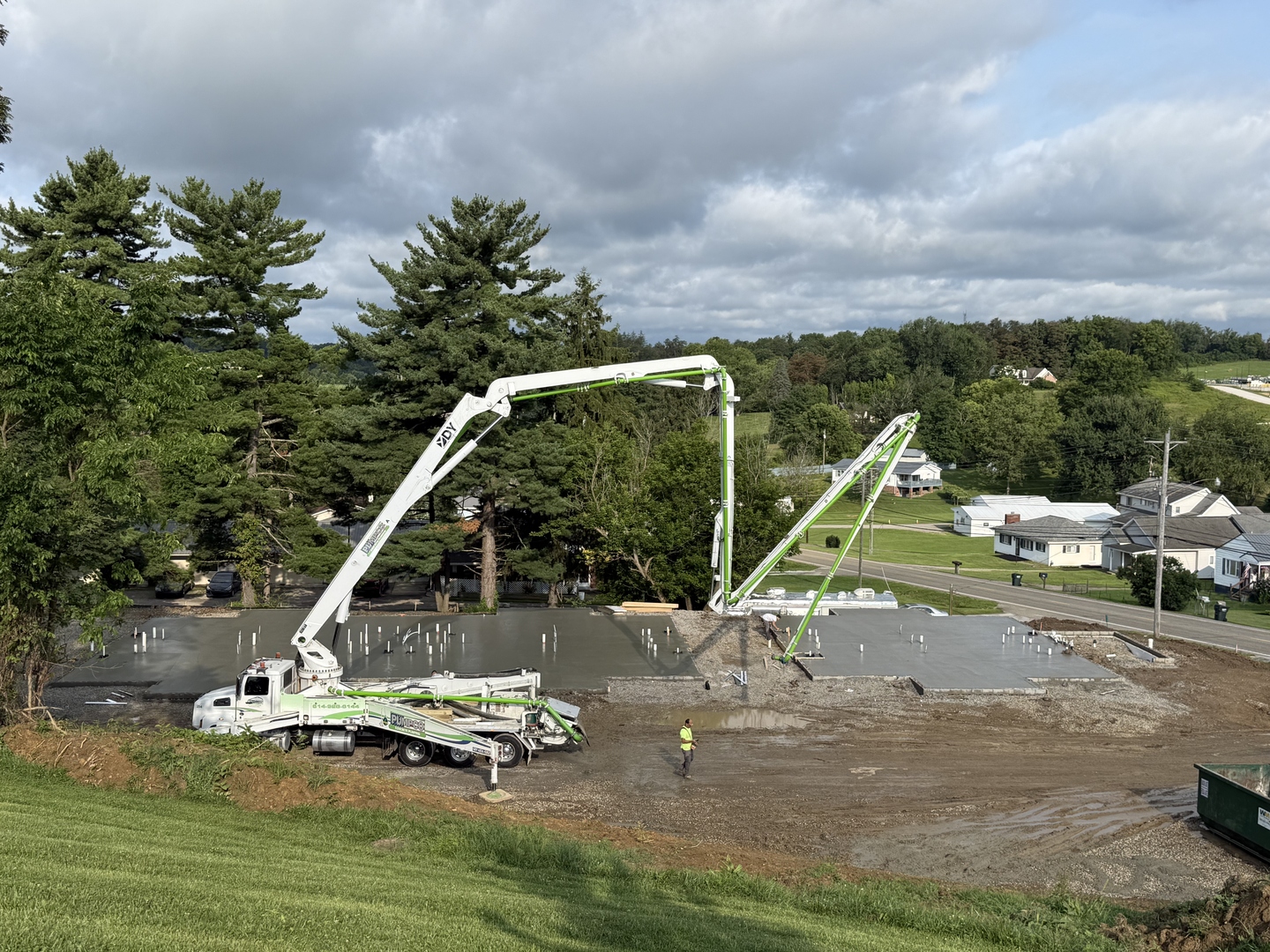 Real construction photo: concrete pump trucks pouring the foundation slabs at The Legacy at Richland Commons, July 2026